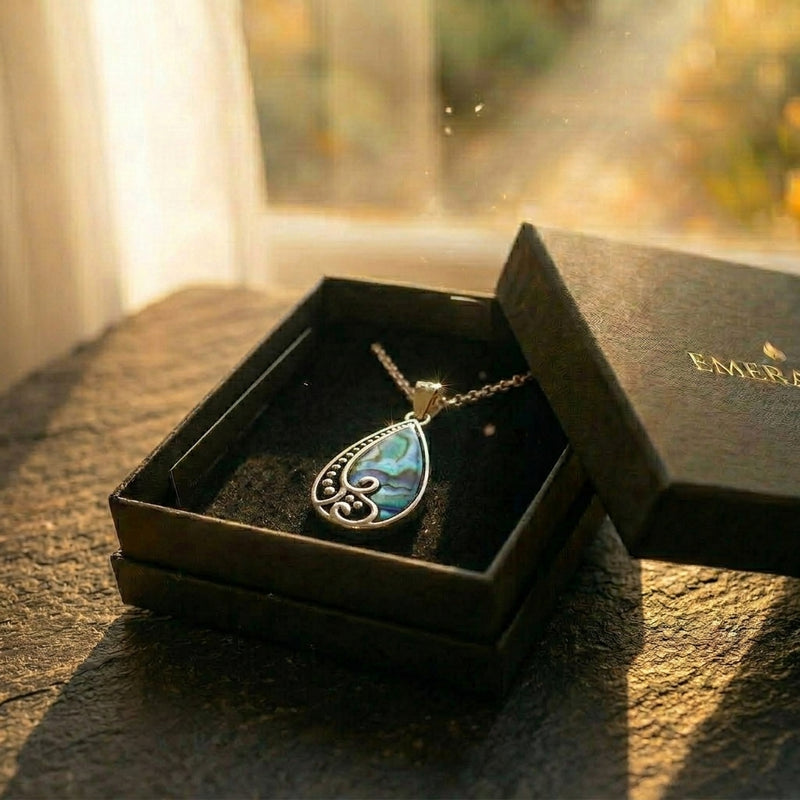 The Ocean Light — silver paua shell pendant with koru detailing from Aotearoa, presented ready to gift in an EMBER box. A considered NZ-made keepsake gift for Mum or someone meaningful.