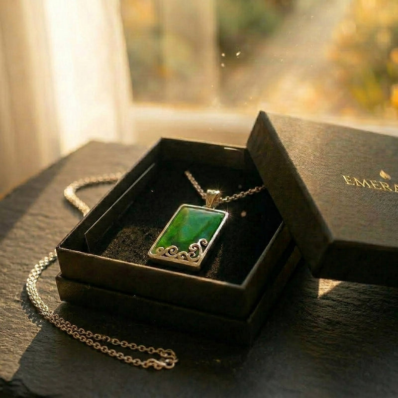 The Holding Stone — rectangular pounamu (greenstone) pendant in silver with carved koru from Aotearoa. A considered NZ-made pounamu keepsake gift for grounding and presence, presented in an EMBER box.