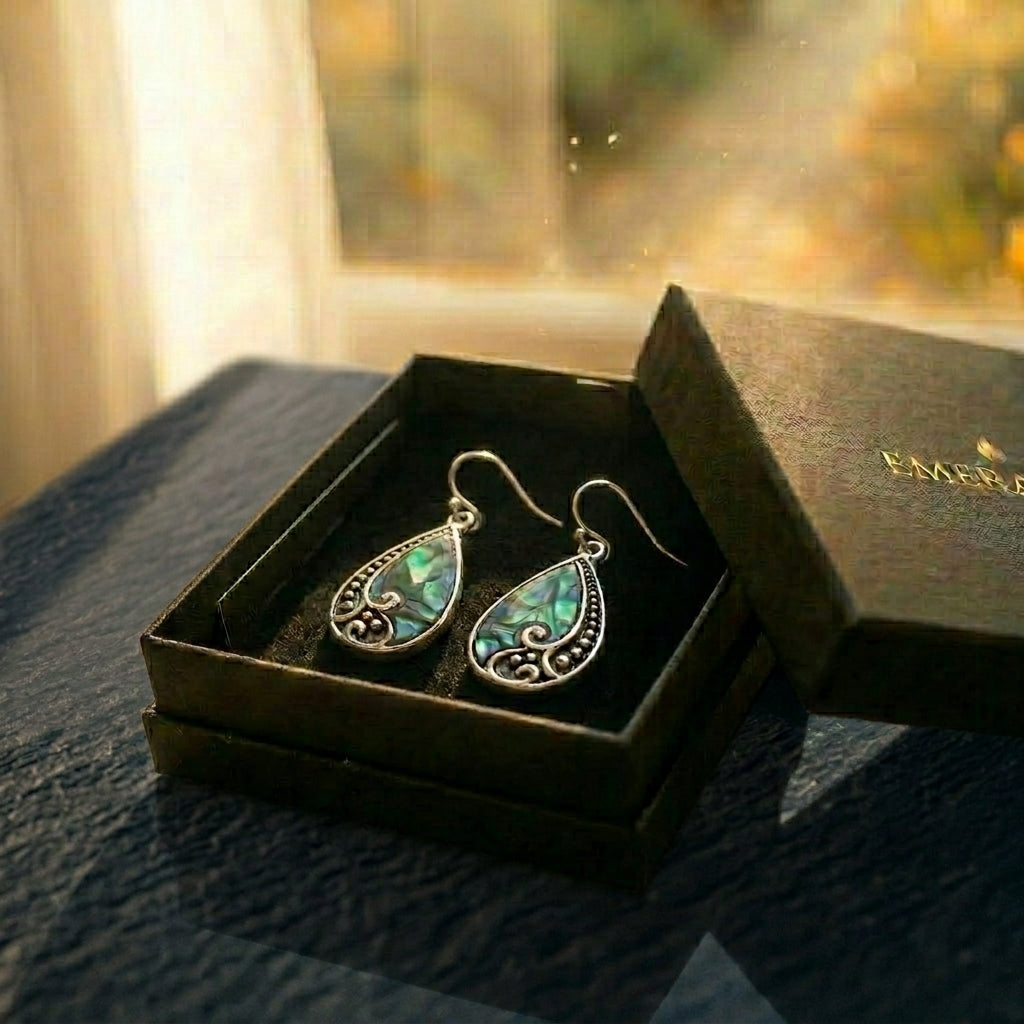 The Tide Drop — silver and paua shell jewellery from Aotearoa, blue-green iridescence catching the light. A considered NZ-made keepsake gift carrying connection to Aotearoa's coast, presented in an EMBER box.